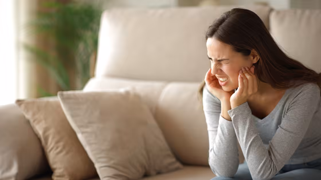 Woman in pain from TMJ